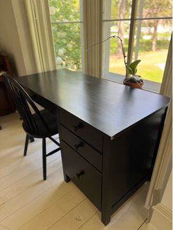 Black wooden desk workstation with chair