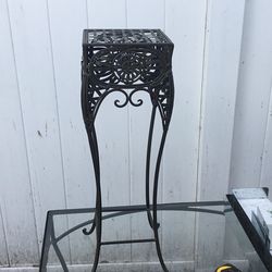 Wrought iron plant stand top is 8” x8” and 25” tall