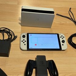 Nintendo switch oled with docking station, charger, Joycon grip and hdmi. NO TRADES CASH ONLY CHECK MY OTHER LISTINGS FOR MORE GAMING STUFF