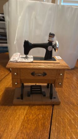 Sewing machine with table music box