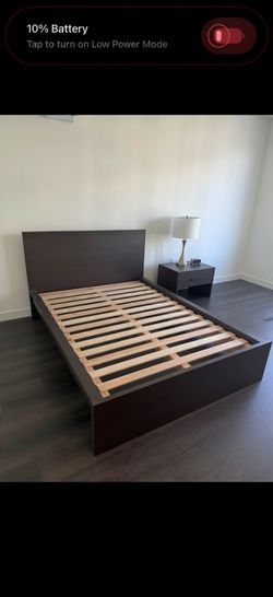 Dark brown platform bed frame with a wood veneer finish. Full Size