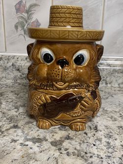 This Happy Guitar Carrying Hat Wearing Bear Cookie Jar