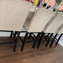4 beige upholstered counter height bar stools