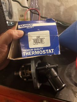 Thermostat and housing assembly