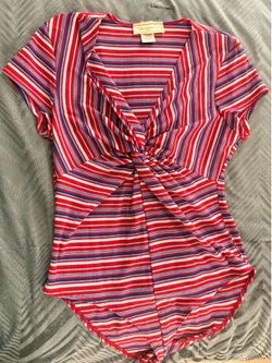 No comment Nyla brand This red, blue, and white striped No Boundaries bodysuit features a trendy front twist detail on sale!!