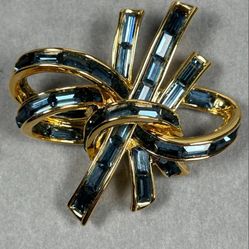 Vintage NOLAN MILLER gold-colored brooch with baguette sapphire glass crystals