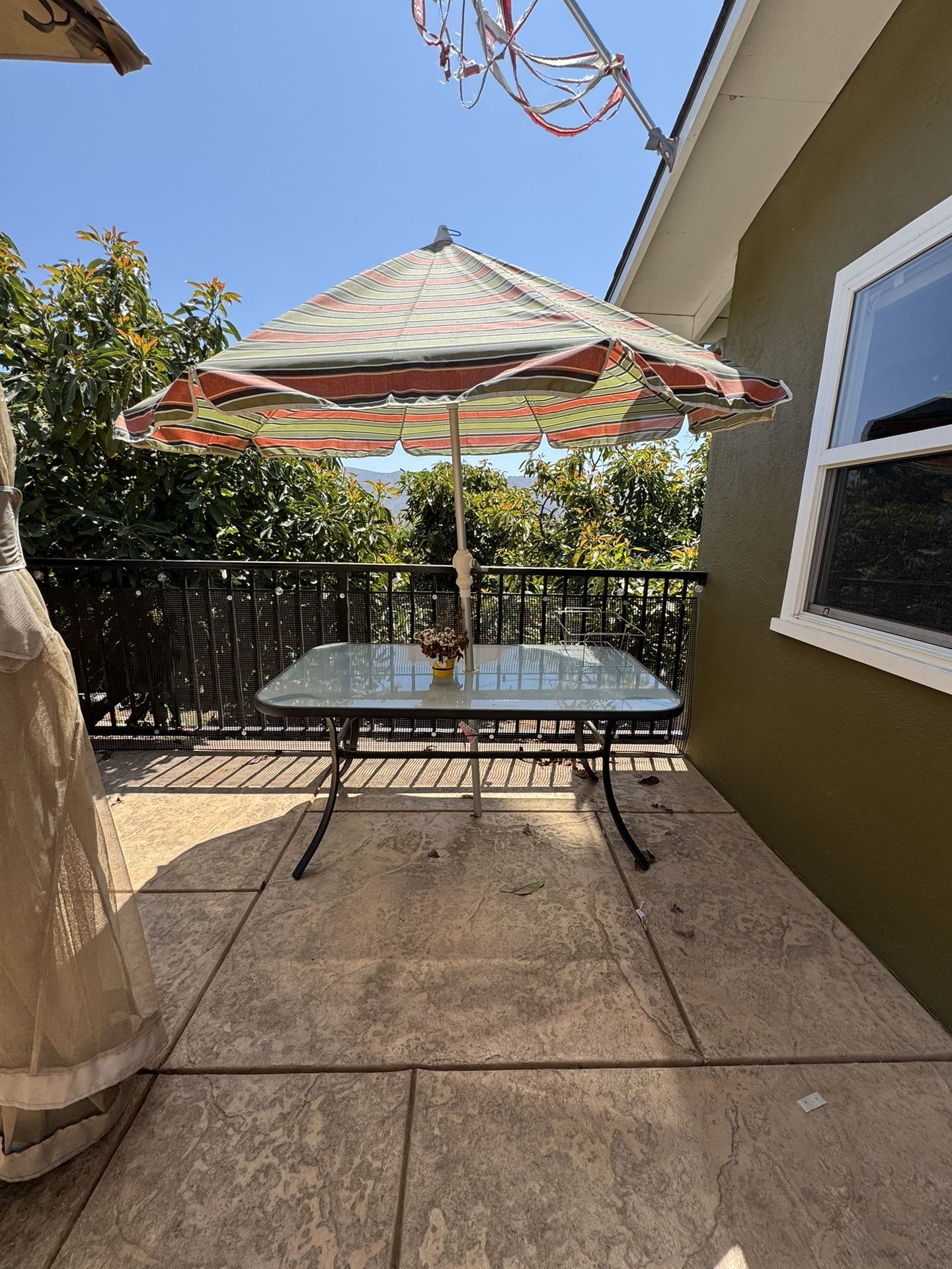 Glass-top patio table with umbrella