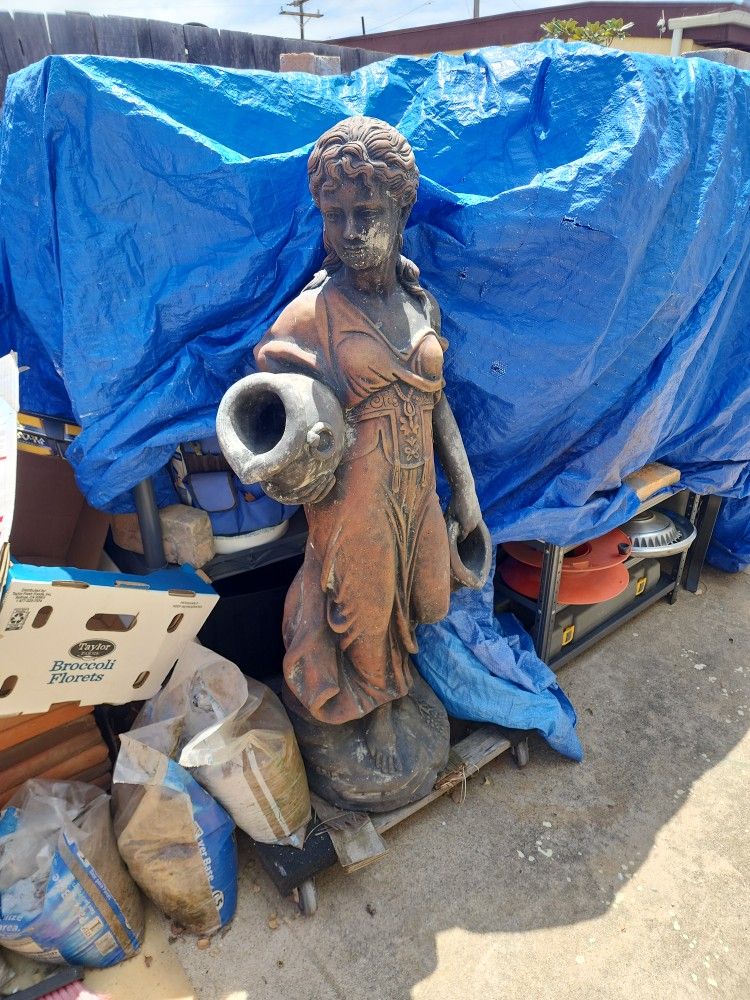 Woman holding two water jars fountain. Make offer.