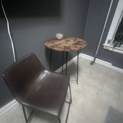 Bistro table and two brown chairs