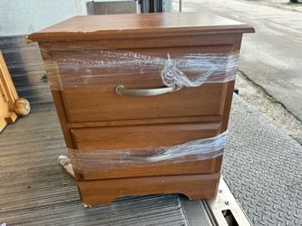 2-drawer wooden nightstand features curved metal handles.
