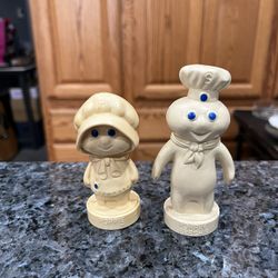Vintage 1974 Pillsbury Doughboy; Poppin' Fresh & Poppie Pair of Salt and Pepper Shakers.  Preowned never used.  The girl turned yellow due to age 