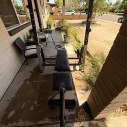 Bench Press Machine And A Lot Of Weights 