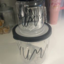 Two storage containers for your pantry that say yummy on it so one big one little