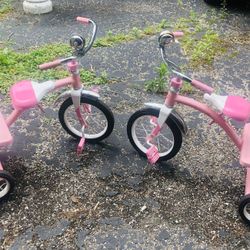 Two Girls, pink radio Flyer tricycles