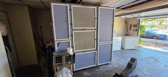 Large Multi-Door Storage Cabinet on Wheels along with Washer and Dryer