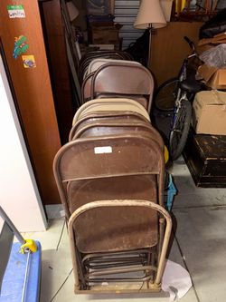 Set of folding chairs and a cart with 2 long tables.