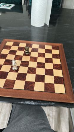 Chess game board with heavy metal pieces