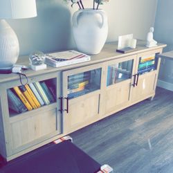 Spacious Wooden Cabinet With Glass Doors, Perfect For Display And Storage.