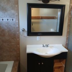 Cabinet,  Counter Top. Faucet,  Mirror And Light Fixture 