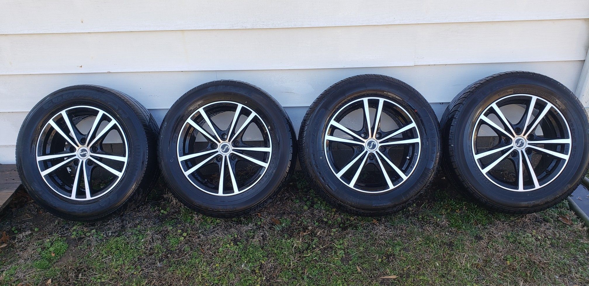 16x7 black and silver rims and tire