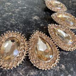 Gold Toned Bib Necklace With Teardrop Shaped Amber Rhinestones