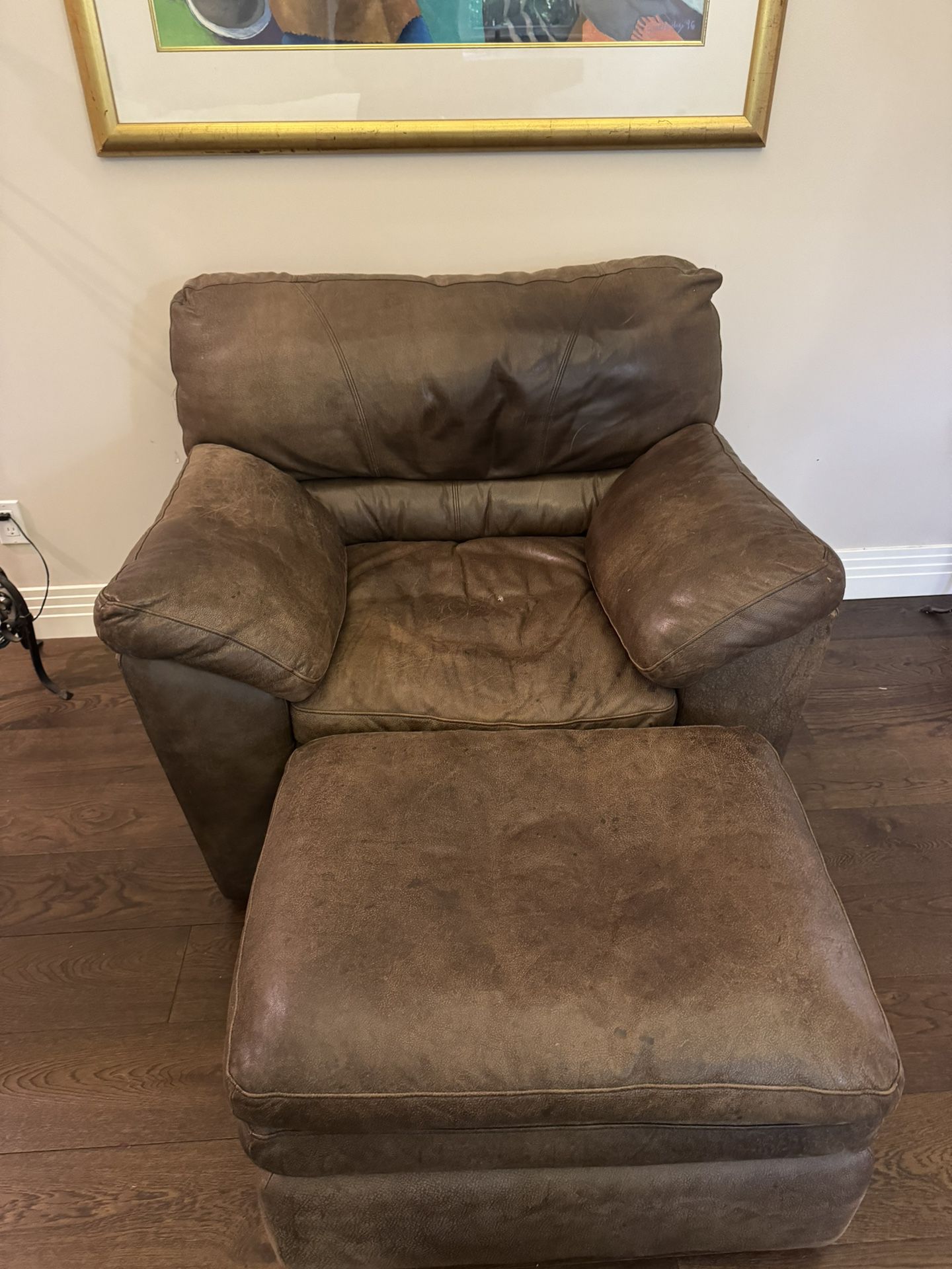 Oversized brown soft plush leather chair and ottoman set.