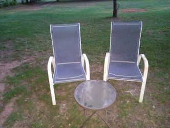Two chairs and a table in good shape