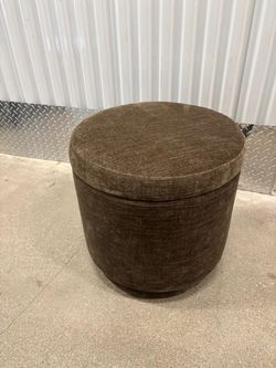 Gray cloth foot stool … in good condition. Swivels With storage space inside .