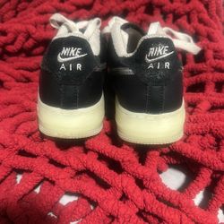 Nike Air Force 1 LV8 in a white and black colorway with a metallic silver swoosh and a translucent outsole