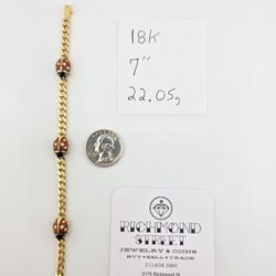 18k gold 7" bracelet featuring enamel ladybugs with ruby eyes