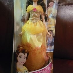Disney Princess Royal Shimmer Belle Doll, identifiable by her signature yellow gown with glitter details and specific packaging art. This particular p