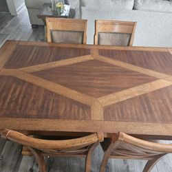  Dining table with 6 chairs and 2 extensions.