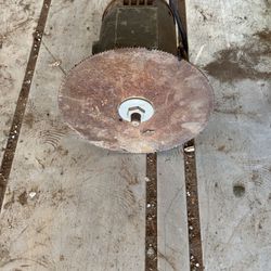 Old electric motor with saw blade