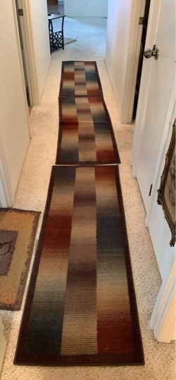 Modern set of three matching runner rugs with a geometric block pattern.