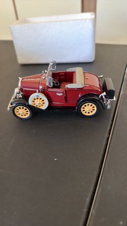 This is a vintage National Motor Museum Mint 1931 Ford Model A Roadster diecast model car in red with cream-colored wheels.