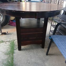ROUND WOODEN TABLE....BROWN IN COLOR