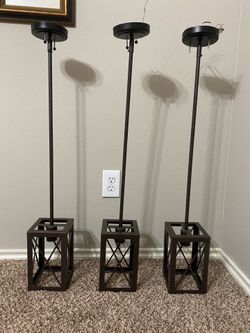 Three Dark Brown Metal Hanging Light Fixtures