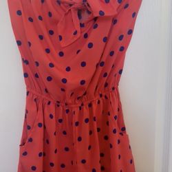 Coral with blue polkadot romper. Size medium.