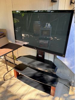 his is a Z-Line Designs TV stand with integrated mount and black glass shelves.