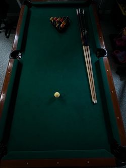 Pool Table with Balls and Cue Sticks
