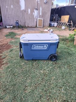 Blue Coleman cooler with wheels