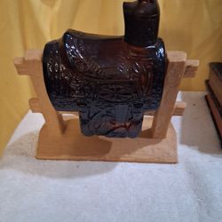 Vintage Avon saddle on fence