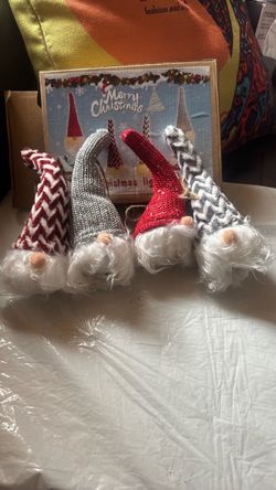 Set of 4 lighted Christmas gnomes decorations with assorted hats. Great on any decor. New in box