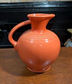 8" x  7.5" Vintage Homer Laughlin Fiestaware Handled Carafe in the retired Persimmon orange glaze color.
