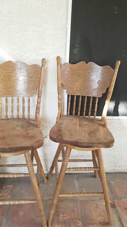 2 oak swivel bar stools.