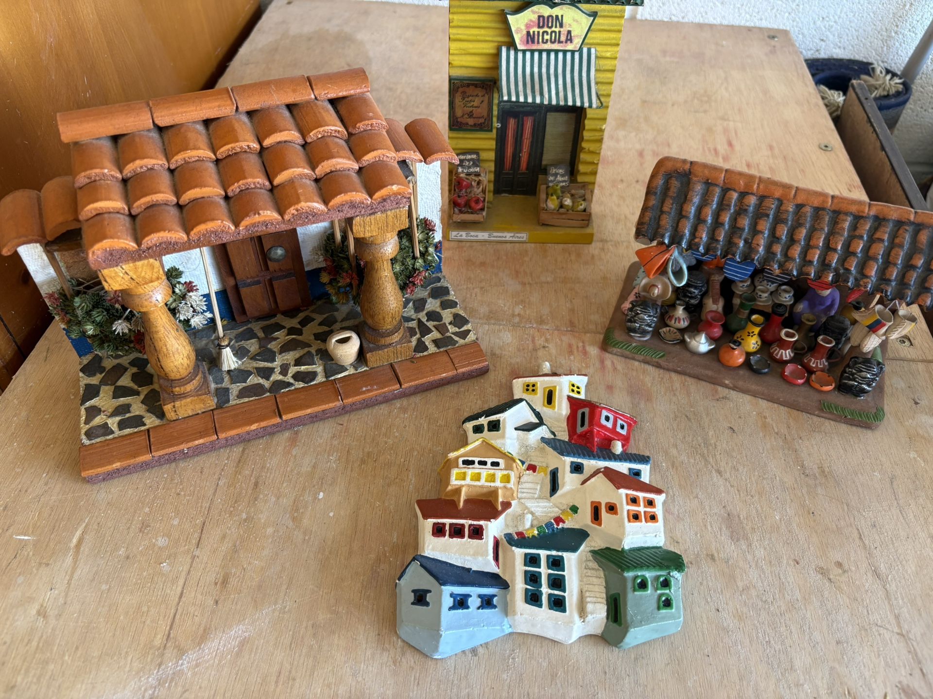 Three little houses made of wood and clay, wall decorations.