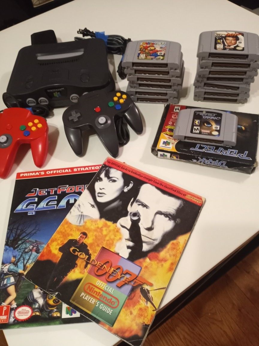 Collector/Player Nintendo 64 bundle with 2 remotes,1 memory card, 14 games, 2 guides,1 box/manual.