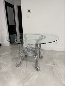 48 inch Round glass dining table with metal base.