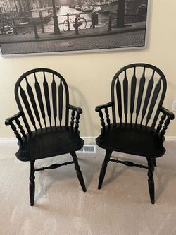 2 black solid wood chairs