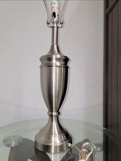 Table lamp Fangio Lighting classic style metal base, featuring a brushed nickel and stainless steel finish and an urn-shaped design. It will not scrat